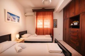 Ένα ή περισσότερα κρεβάτια σε δωμάτιο στο Aptera Dream Apartment