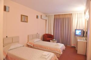 サンダンスキにあるСемеен Хотел Соколのベッド2台とテレビが備わるホテルルームです。