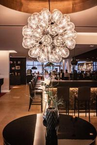 a chandelier in a restaurant with a table and chairs at Romantik Hotel Kleber Post in Bad Saulgau