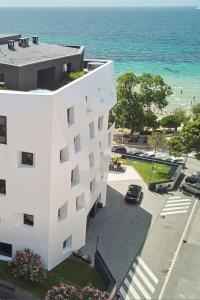 a white building with the ocean in the background at briig boutique hotel in Split