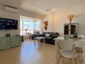 a living room with a couch and a table at City & Beach Top-Floor Apartment in Fuengirola