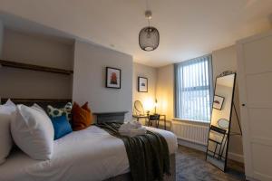 a bedroom with a large white bed and a window at The Chancery, Stunning Home Nr City Stadium, Principality Stadium and City Centre in Cardiff