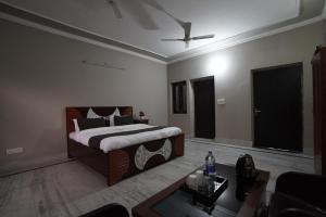 a bedroom with a bed and a living room at Sun flower Residency in Greater Noida