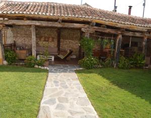 a house with a patio and a grass yard at Laguna Herrera in Campo de Cuéllar