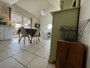 a kitchen and dining room with a table and chairs at Gîte de la Valière in Chevigny-en-Valière +30 photos