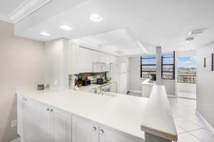 a kitchen with white cabinets and a white counter top at South Seas Tower 4-704 in Marco Island