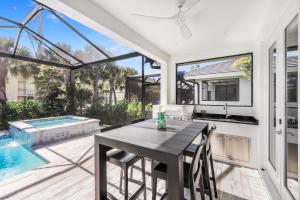 a kitchen and dining room with a table and a swimming pool at 280 West Flamingo Circle in Marco Island