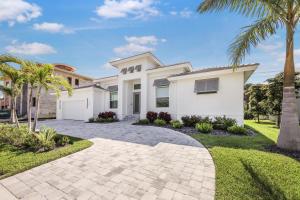a white house with palm trees and a driveway at 280 West Flamingo Circle in Marco Island
