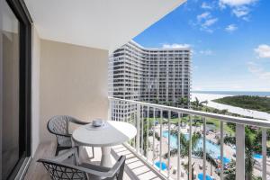 a balcony with a table and chairs and a view of a building at South Seas Tower 4-704 in Marco Island