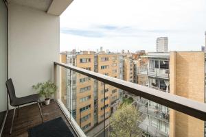 a balcony with a chair and a view of a city at Immaculate 1-Bed Apartment in London in London