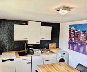 a kitchen with a sink and a washing machine at Messe 3 Minutes in Hannover