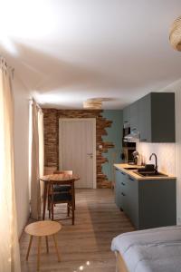 eine Küche mit einem Tisch und eine kleine Küche mit einem Esszimmer in der Unterkunft Rêverie du Val in Triembach-au-Val
