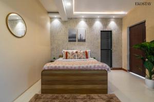 a bedroom with a bed and a mirror at EKO STAY- PANORAMA VILLA in Alibaug