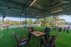 a group of tables and chairs under a tent at EKO STAY- PANORAMA VILLA in Alibaug