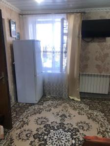 a kitchen with a refrigerator and a window at Sweet house 1 in Gyumri