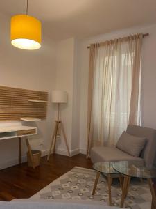 a living room with a couch and a glass table at Palazzo Venezian 5 in Trieste