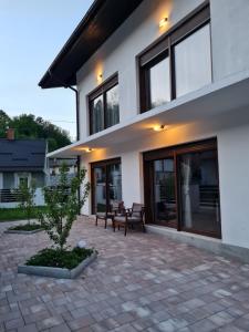 a house with a patio with two benches in front of it at OLD TOWN ROAD in Karlovac