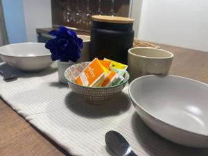 a table with three bowls on a table at HOMEY I Palazzo Venezian Apartments in Trieste +15 photos