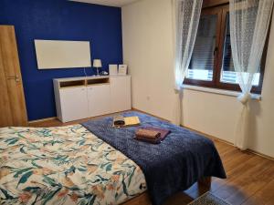 a bedroom with a bed with a blue wall at OLD TOWN ROAD in Karlovac