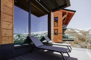 a pair of chairs on the balcony of a house at Arttysur Lux - Best 4 BDRM Villas in Sierra Nevada in Sierra Nevada