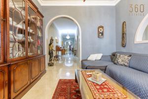 a living room with a couch and a table at A Lovely 3BR Maisonette in lovely town of Rabat by 360 Estates in Busugrilla