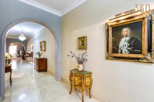 a room with a painting of a man on the wall at A Lovely 3BR Maisonette in lovely town of Rabat by 360 Estates in Busugrilla +45 photos