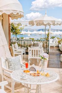 a white table with food on top of a balcony at Miramare E Castello in Ischia