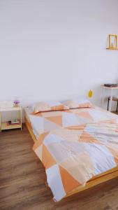a bedroom with a bed with an orange and white comforter at Joie Home in Nha Trang