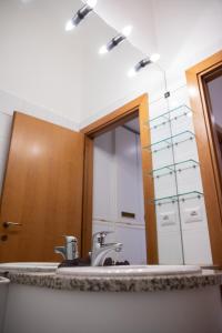 uma casa de banho com um lavatório e um espelho em Appartamento milano, Bruna House em Milão