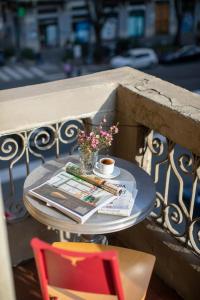 uma mesa com um jornal e uma chávena de café e uma revista em Appartamento milano, Bruna House em Milão