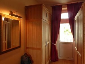 a room with a cabinet and a window and a mirror at Fürstenhof - Ferienwohnung 204 in Sassnitz