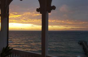 a view from a window of the ocean at sunset at Fürstenhof - Ferienwohnung 204 in Sassnitz