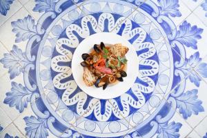 a plate of food on a blue and white plate at Miramare E Castello in Ischia