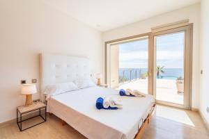 a bedroom with a bed with blue flip flops on it at Vista Mar by Mallorca House Rent in Manacor +26 photos