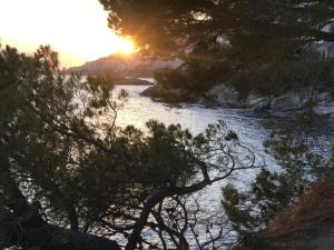 un fiume con alberi e il sole sullo sfondo di SANTA BARBARa a Roses