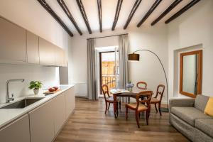a kitchen and dining room with a table and a couch at Boutique Hotel Campo de' Fiori in Rome