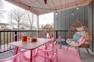 a patio with pink chairs and a table and a table and chairs at Butterfly BNB~Modern Luxury~Giant Rooftop~9Min DT in Nashville
