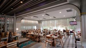 a restaurant with tables and chairs in a room at FIM by Zigna in Solo