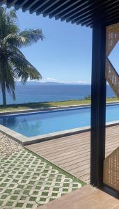 a swimming pool with a view of the ocean at Morika Villa in Rua