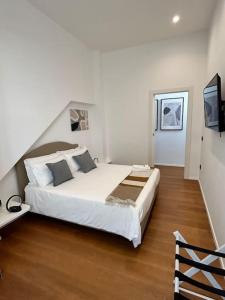 a bedroom with a large bed and a television at Loft Metro Mergellina in Naples