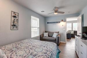 a bedroom with a bed and a couch and a chair at The Blue Pearl in Port Aransas