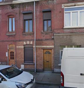 a white van parked in front of a brick building at Balnéo Blanche Porte in Tourcoing