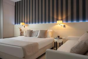 Cama ou camas em um quarto em Hotel Villa Rosa Riviera