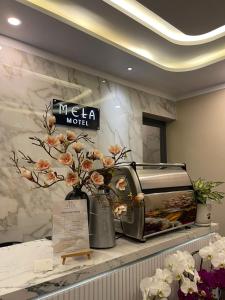 a counter with flowers in vases and a toaster at MELA HOTEL in Mỹ Thạch