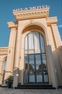 a building with a large window on the front at MELA HOTEL in Mỹ Thạch +15 photos