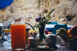 a jug of orange juice sitting on a table at Sweet Water Caminito del Rey in Carratraca