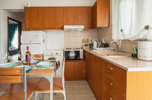 A kitchen or kitchenette at Basiliki's Apartments
