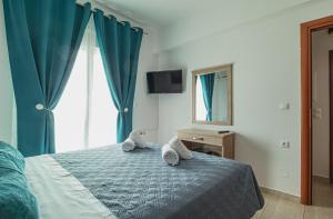 A bed or beds in a room at Basiliki's Apartments