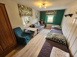 a living room with two beds and a couch at Osmelakowa Dolina in Spalona