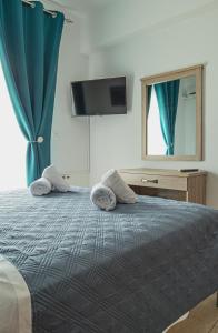 A bed or beds in a room at Basiliki's Apartments